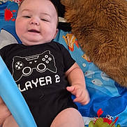 Noah is registered to the contest to win money with this photo: animal, baby, cat, child, colorful, comfort, cute, floor, happy, indoor, infant, lying_down, onesie, orange_cat, pet, play_mat, playtime, smiling, toy, young_child