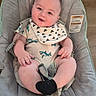 baby, baby_boy, baby_seat, bib, black_sock, child, clothing, cushion, cute, happy, indoor, infant, onesie, portrait, seat, shark_pattern, small_feet, small_hands, smiling, wooden_floor
