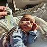 Kingston is registered to the contest to win money with this photo: newborn, baby, infant, sleeping, hospital, hospital_bed, feeding_tube, medical_tube, monitoring_wire, bottle, pacifier, blanket, blue_clothing, swaddled, face, hand, indoors, sunlight, portrait, medical_care