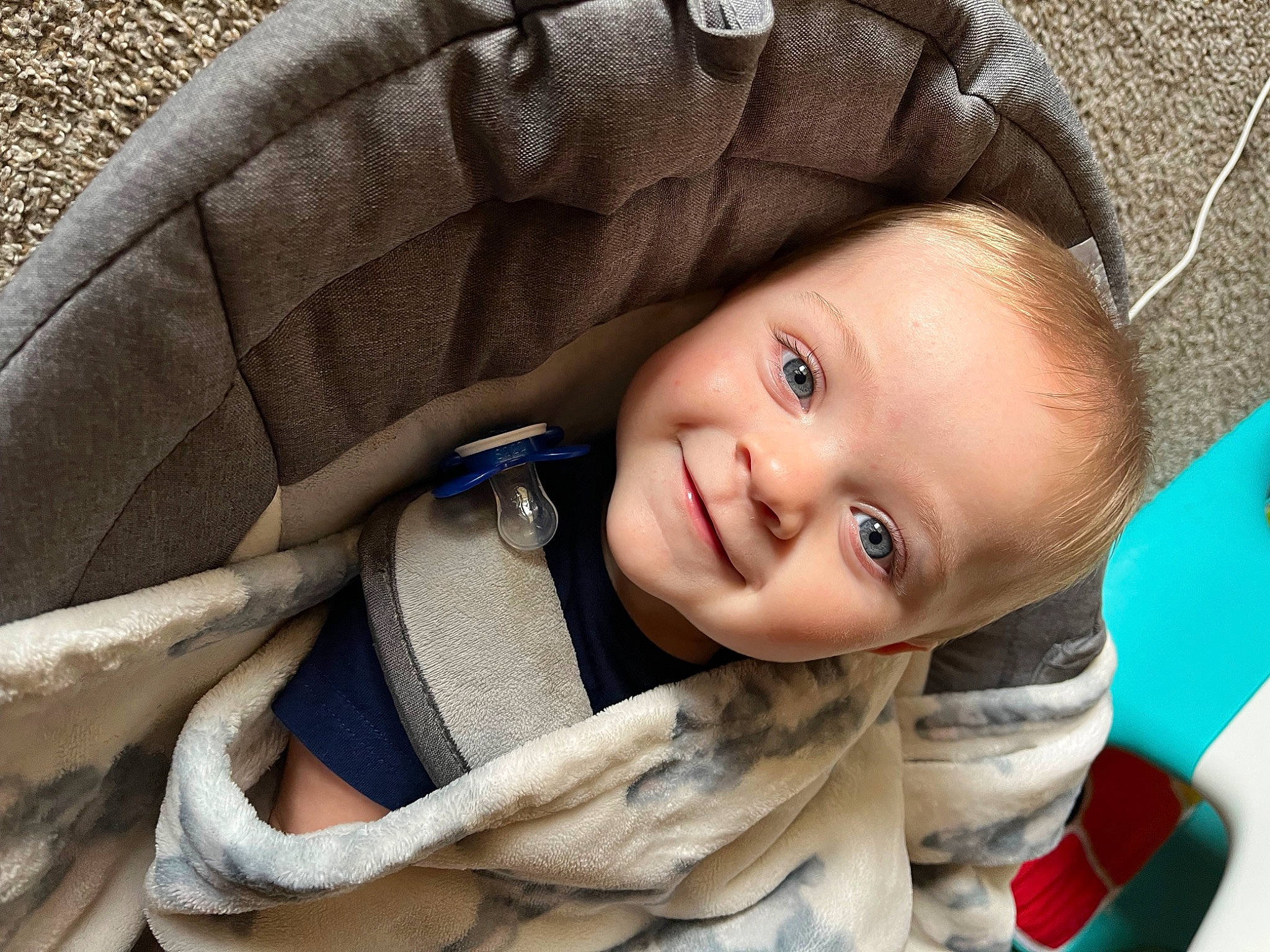 Jaxon is registered to the contest to win money with this photo: baby, baby_toddler_clothing, cheek, child, clothing, comfort, eye, face, facial_expression, flash_photography, grass, happy, iris, joy, person, sitting, skin, smile, toddler, tree