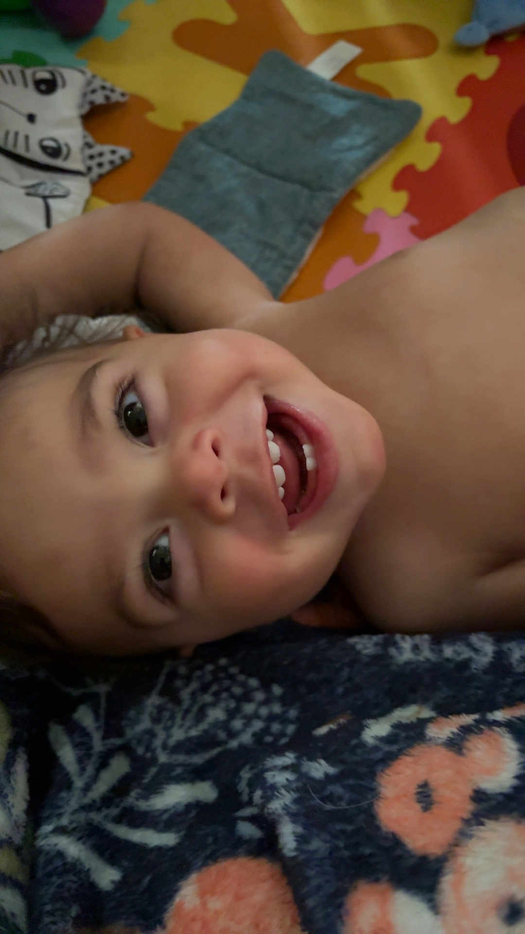Julian joined the competition — help win amazing prizes! baby, smiling, face, teeth, eyes, skin, blanket, play_mat, child, happy, infant, lying_down, closeup, cute, expression, head, indoors, cheerful, young, person