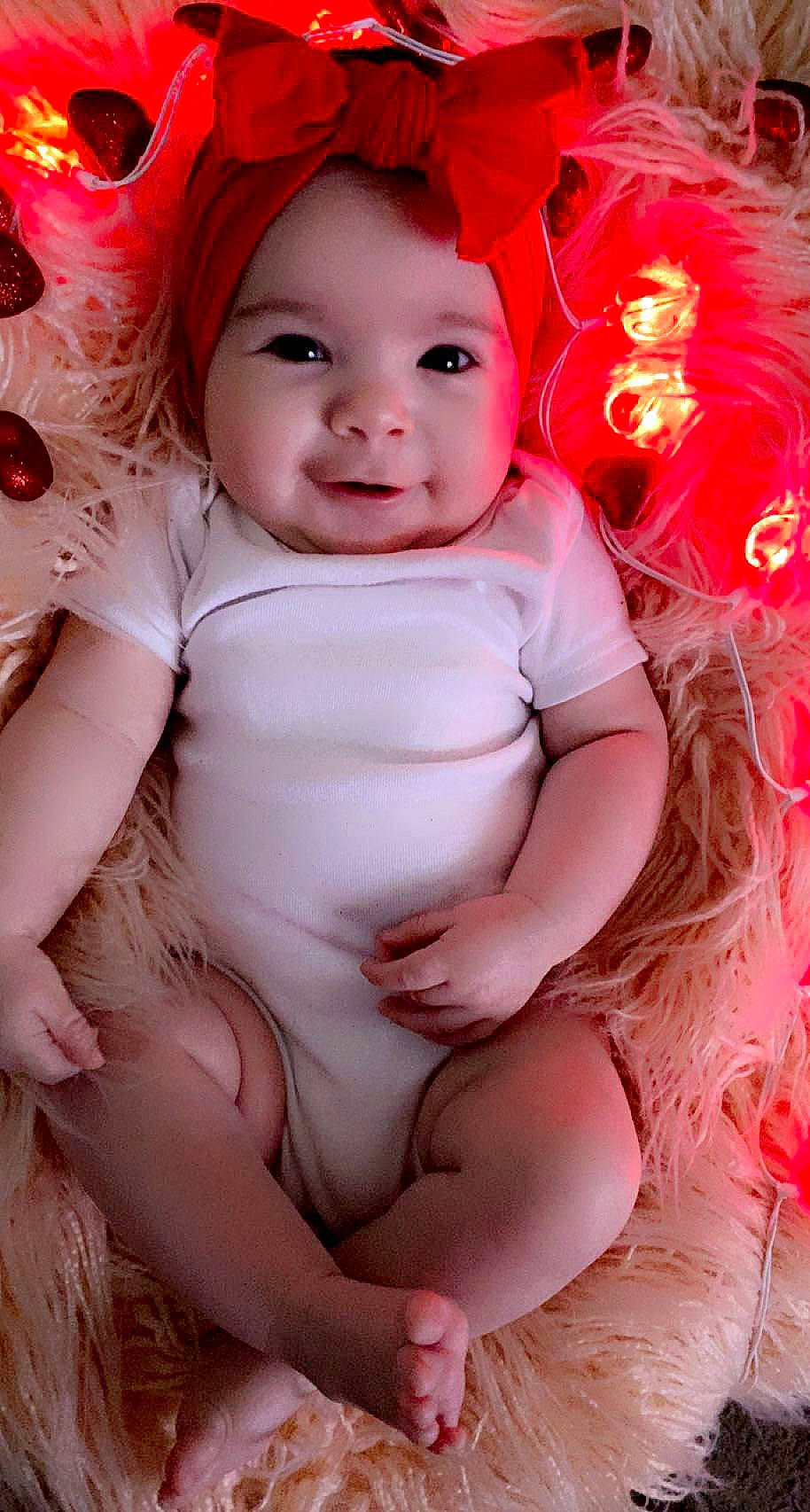 Rai'Nah is registered to the contest to win money with this photo: baby, baby_toddler_clothing, cap, cheek, child, eye, face, facial_expression, flash_photography, happy, head, headwear, human_body, human_leg, lip, person, pink, red, skin, smile