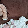 baby, infant, sleeping, blanket, brown, knitwear, headband, teddy_bear, soft_toy, cozy, cute, newborn, child, resting, indoor, person, portrait, clothing, peaceful, comfort