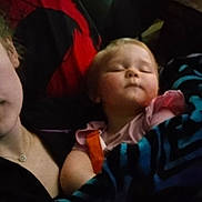 Persephone is registered to the contest to win money with this photo: toddler, sleeping, blanket, child, person, indoor, resting, cozy, comfort, pink_clothing, face, head, peaceful, nap, candid, holding, relaxing, young_child, soft_light, quiet