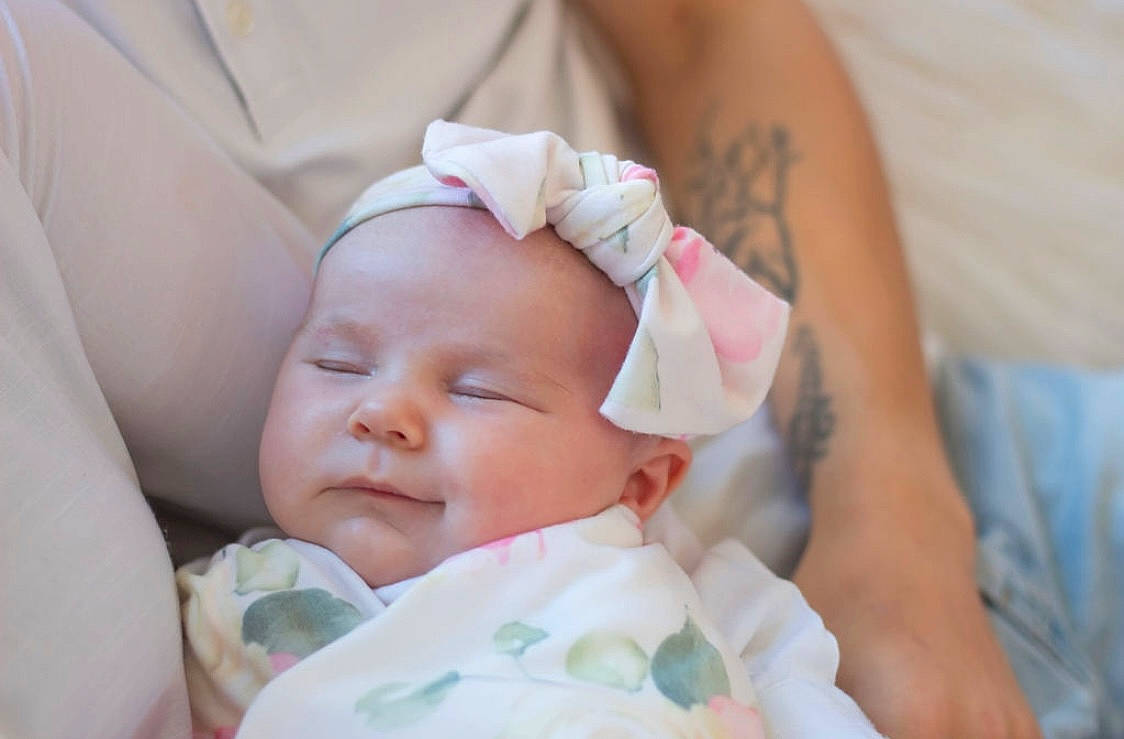 Aubriella is registered to the contest to win money with this photo: baby, baby_toddler_clothing, cheek, child, comfort, event, eyelash, grass, happy, hat, headwear, pattern, peach, person, portrait_photography, skin, sleep, toddler