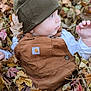baby, child, fall, leaves, overalls, knit_hat, outdoor, nature, curious, autumn, seasonal, portrait, side_profile, clothing, cute, person, young_child, fall_leaves, baby_girl, baby_boy