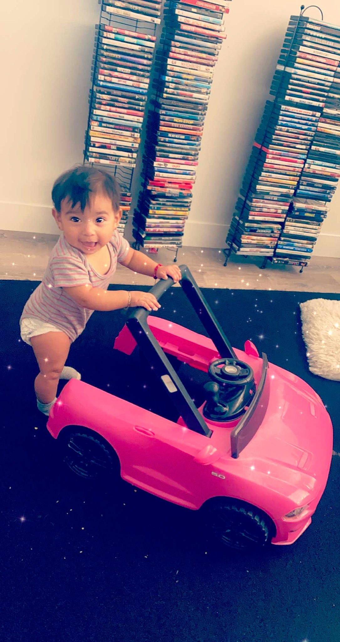 Selena joined the competition — help win amazing prizes! automotive_design, automotive_lighting, blue, car, hand, happy, light, mode_of_transport, motor_vehicle, person, photograph, pink, product, purple, red, riding_toy, tire, toddler, toy, vehicle