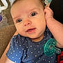 baby, infant, child, face, eyes, smile, blue_shirt, polka_dots, pacifier, hand, arm, person, indoors, cozy, comfort, close_up, skin, cute, young, portrait