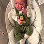 Anya is registered to the contest to win money with this photo: baby, infant, face, expression, clothing, overalls, winnie_the_pooh, green, white_socks, cushion, baby_seat, soft_texture, indoor, cute, child, newborn, hand, footwear, patterned_fabric, cozy