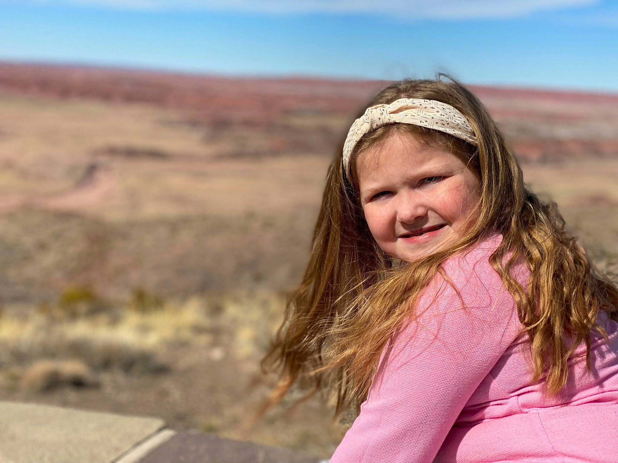 Daniella is registered to the contest to win money with this photo: blond, brown_hair, ecoregion, face, flash_photography, fun, grass, grassland, happy, headwear, horizon, joy, landscape, leisure, long_hair, people_in_nature, person, recreation, sand, sky