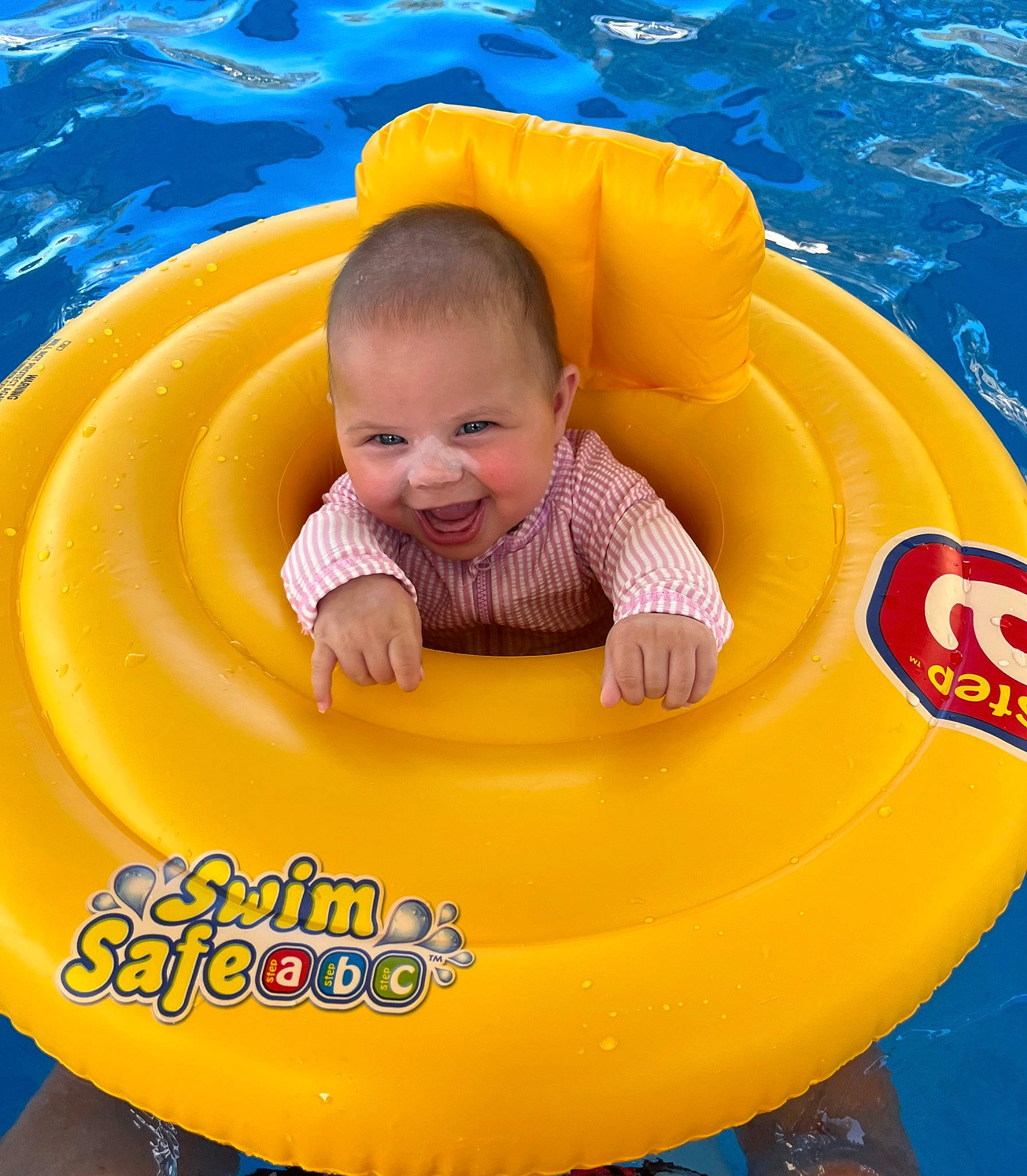Millie joined the competition — help win amazing prizes! baby, baby_float, baby_products, baby_toddler_clothing, bathing, blue, child, circle, facial_expression, fun, happy, inflatable, joy, leisure, person, play, product, recreation, smile, swimming_pool