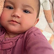 Leah joined the competition — help win amazing prizes! baby, child, face, portrait, onesie, blanket, soft_texture, close_up, infant, cute, cozy, sleepwear, home, relaxing, young_child, skin, person, eyebrows, head, earring