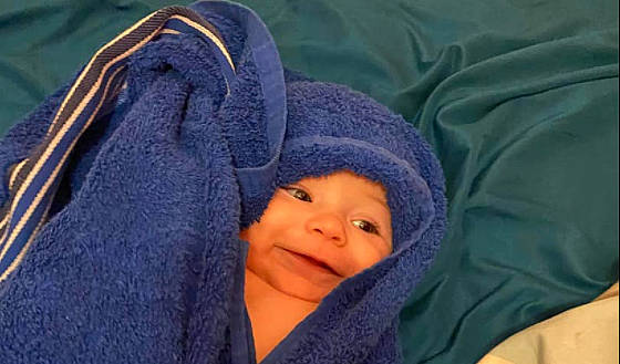 Kolson joined the competition — help win amazing prizes! baby, baby_products, beanie, cap, cheek, child, comfort, electric_blue, headwear, knit_cap, linens, nap, nose, person, purple, sitting, skin, textile, thumb, toddler