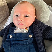 Rafaël participe au concours pour gagner de l'argent avec cette photo : baby, infant, child, face, head, blue_overalls, knitted_sweater, cushion, sofa, indoors, portrait, resting, light_skin, red_hair, young_child, clothing, comfort, close_up, expressionless, casual