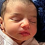 newborn, baby, sleeping, infant, face, close_up, portrait, lips, nose, eyelids, hair, skin, cheek, blanket, onesie, fabric, soft_texture, peaceful, rest, eyebrow