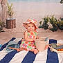 baby, child, floral_dress, sunhat, striped_towel, beach_toys, indoor, smiling, playing, bucket, shovel, flowers, plants, background, portrait, sitting, cute, happy, summer, toddler