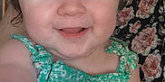 Kamëlya participe au concours pour gagner de l'argent avec cette photo : arm, baby, blue_eyes, child, closeup, cute, expression, face, floral_pattern, green_dress, hand, happy, human, indoor, infant, person, portrait, skin, smiling, young_child