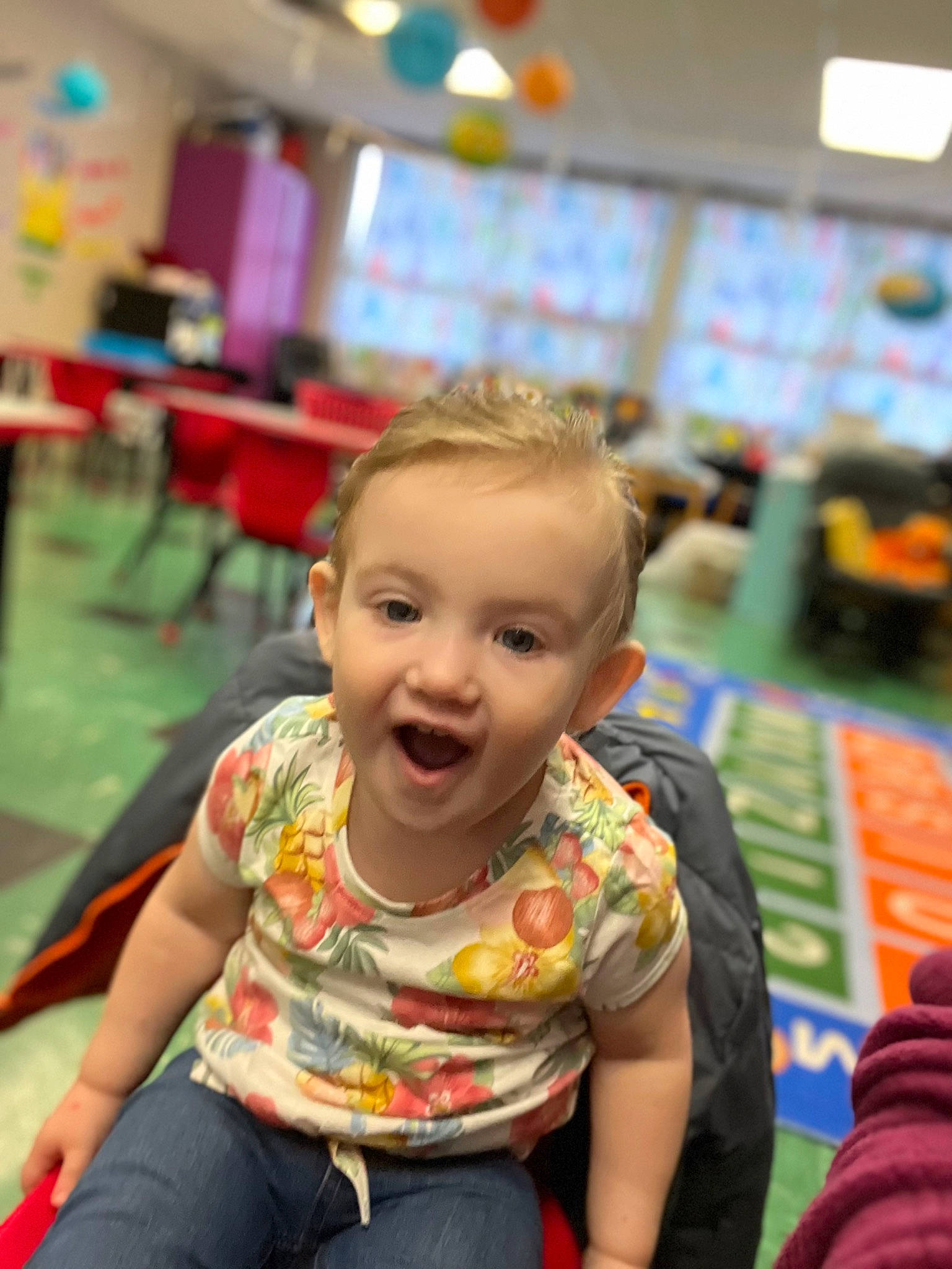 Elizabeth is registered to the contest to win money with this photo: chair, cheek, child, event, flooring, fun, happy, jeans, kindergarten, leisure, person, play, recreation, room, sitting, skin, smile, snapshot, t_shirt, toddler