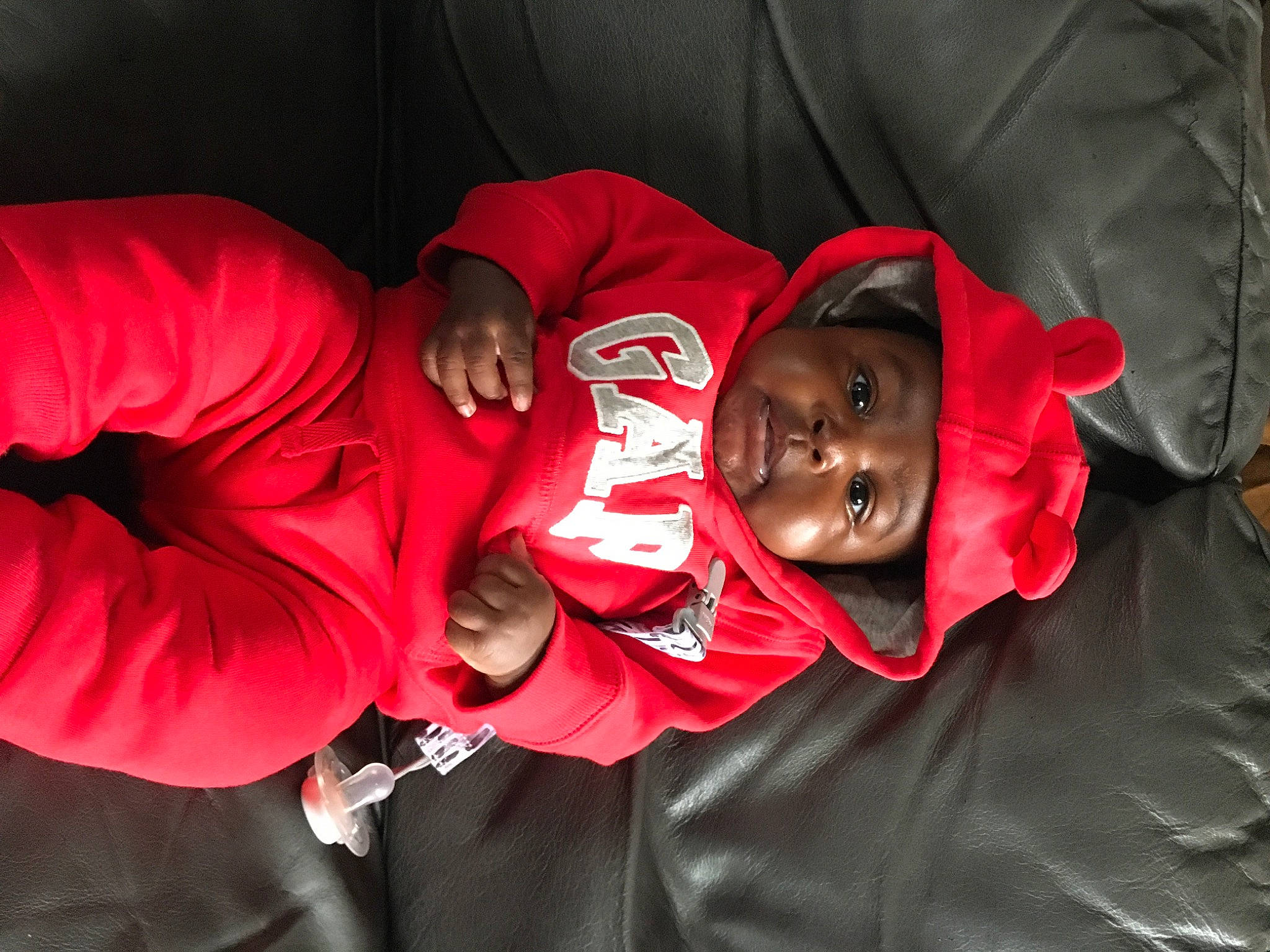 King is registered to the contest to win money with this photo: baby, carmine, child, comfort, event, fun, happy, hat, headwear, magenta, person, sleeve, smile, t_shirt, toddler, tradition, tree