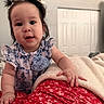 baby, child, infant, girl, pigtails, hair, blue_dress, flower_pattern, hand, blanket, bedroom, door, red_skirt, fabric, indoor, person, cute, portrait, smiling, skin