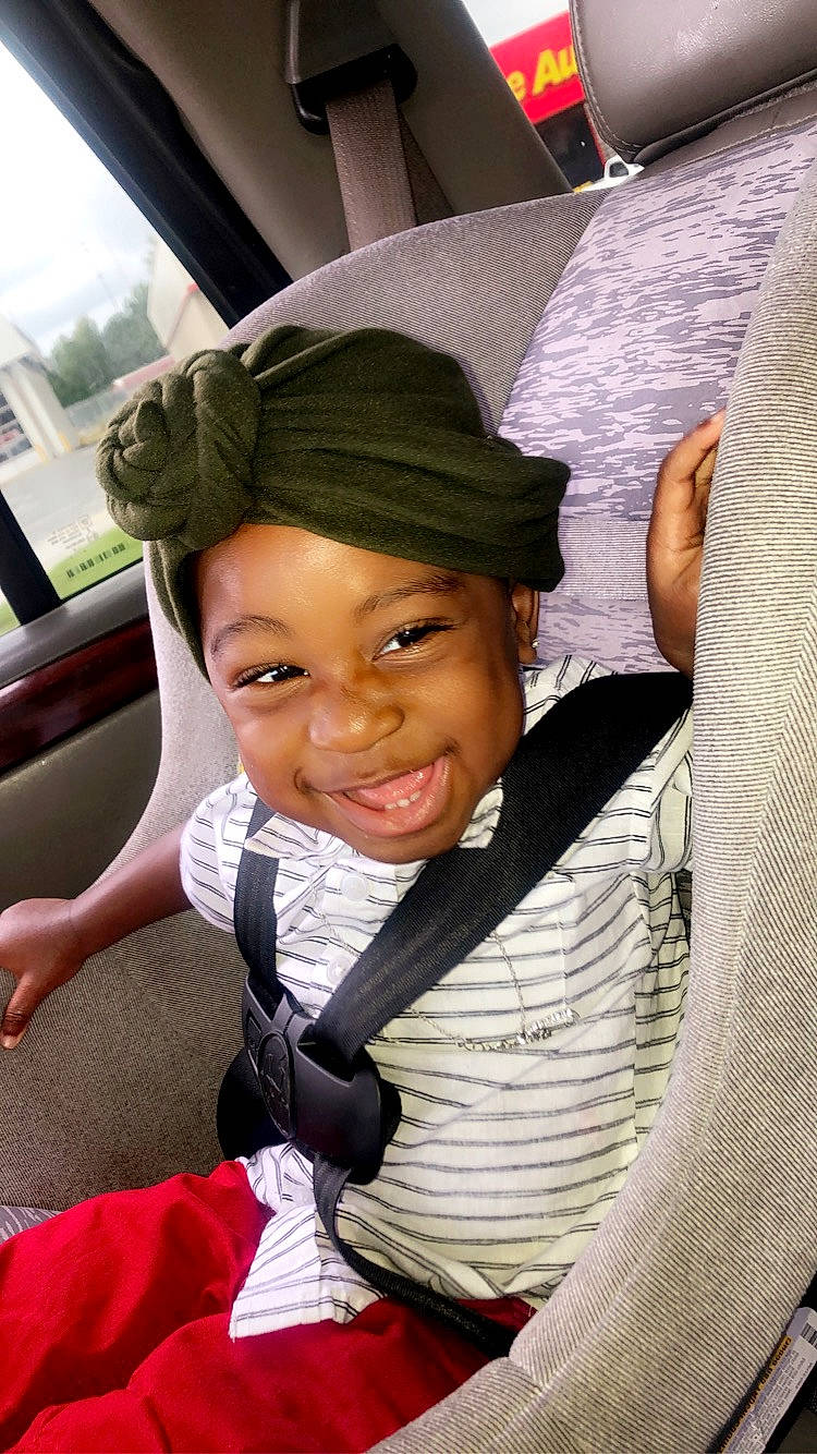 Jataveon is registered to the contest to win money with this photo: auto_part, black_hair, cap, child, cool, fashion_accessory, fun, hairstyle, happy, hat, headgear, headwear, joy, motor_vehicle, mouth, person, sitting, smile, sun_hat, thumb