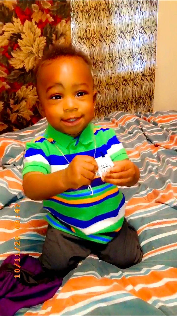 Jataveon joined the competition — help win amazing prizes! baby, baby_toddler_clothing, cheek, child, comfort, eye, face, fun, hair, hairstyle, happy, head, joy, leisure, linens, orange, person, room, sitting, skin