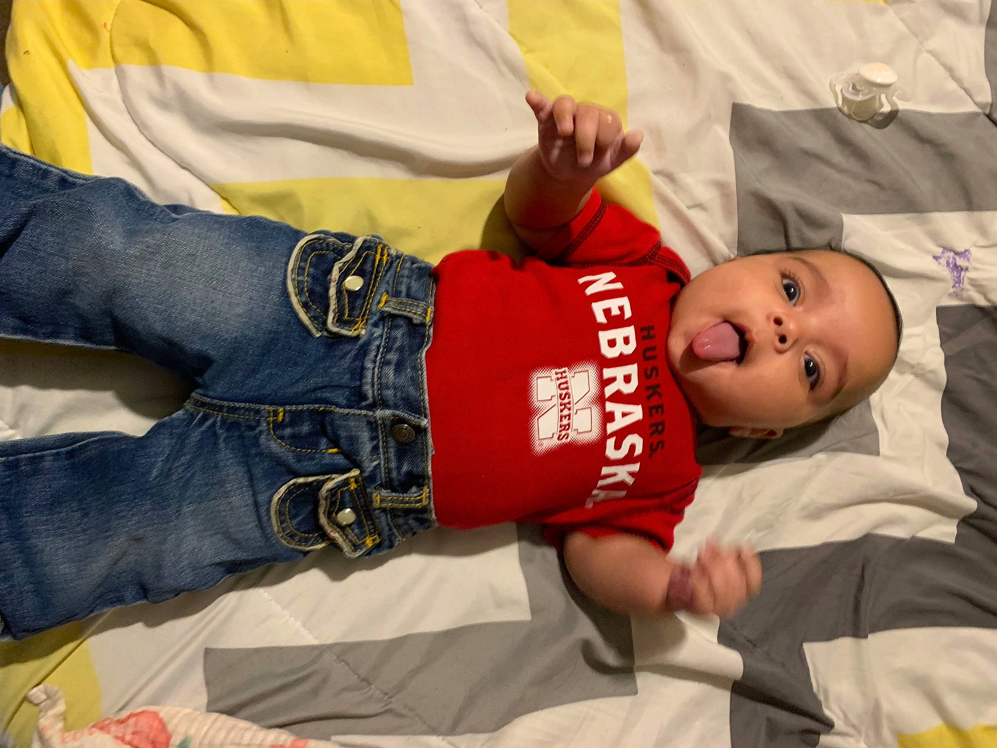 Millie is registered to the contest to win money with this photo: abdomen, baby, baby_toddler_clothing, child, comfort, elbow, event, gesture, happy, hat, human_body, human_leg, knee, person, room, smile, t_shirt, thigh, toddler, tree