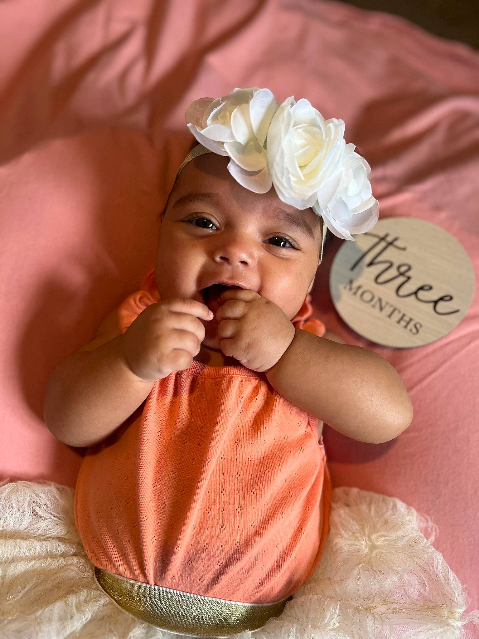 Millie joined the competition — help win amazing prizes! baby, baby_toddler_clothing, cheek, finger, flower, hair_accessory, hairstyle, hand, happy, headband, headgear, headpiece, headwear, nail, orange, peach, person, petal, pink, skin