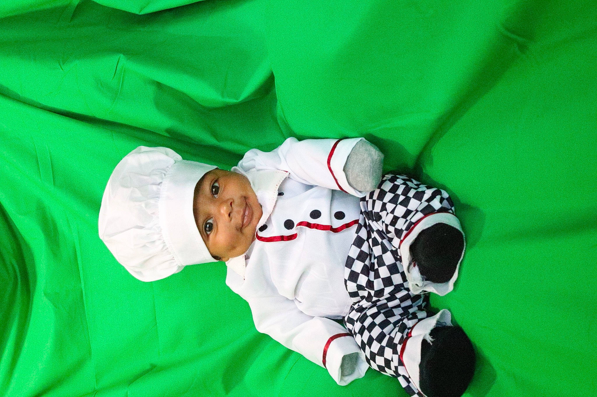 Nyaire is registered to the contest to win money with this photo: baby, baby_toddler_clothing, carmine, child, comfort, event, grass, happy, hat, headwear, leisure, linens, pattern, person, sleeve, toddler