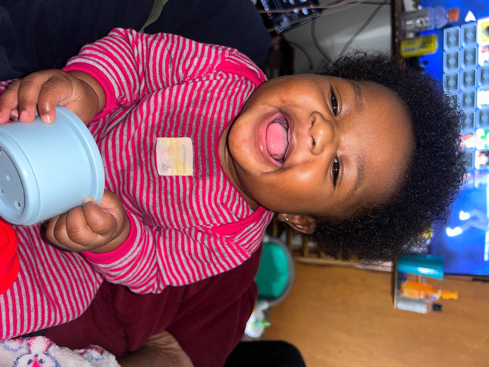 Bria is registered to the contest to win money with this photo: child, cup, drink, drinking, drinkware, fun, happy, magenta, mug, nail, party, person, plastic_bottle, room, skin, smile, thumb, toddler