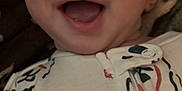 Rook joined the competition — help win amazing prizes! baby, infant, smiling, face, onesie, clothing, sleepwear, cute, happy, mouth_open, eyes, head, skin, child, portrait, lying_down, blanket, patterned_clothing, indoors, closeup