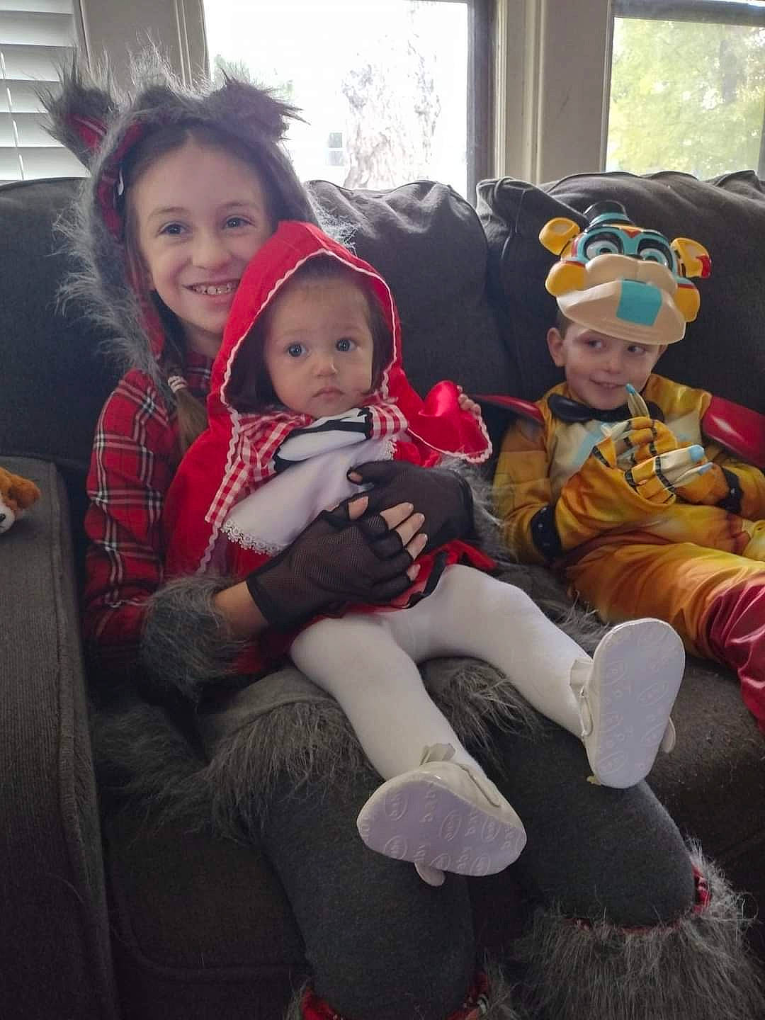 Emily is registered to the contest to win money with this photo: baby, child, christmas, christmas_eve, comfort, event, fun, happy, headwear, holiday, joy, lap, leisure, living_room, person, room, sitting, smile, toddler, tree