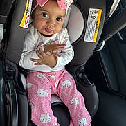 Alysha joined the competition — help win amazing prizes! baby, car_seat, pink_clothing, headband, hello_kitty, child, infant, hands, black_shoes, car_interior, seatbelt_warning, cute, portrait, sitting, young_child, indoors, person, clothing, footwear, expression