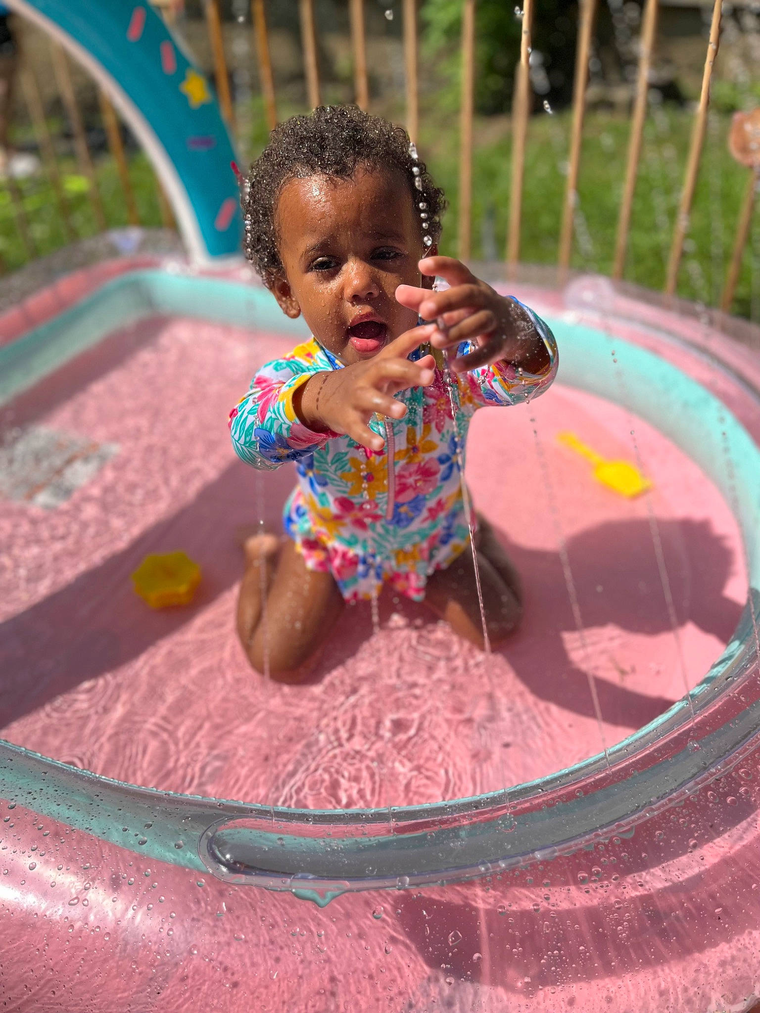 Kadasia joined the competition — help win amazing prizes! baby, baby_toddler_clothing, bathing, child, circle, fun, grass, happy, leisure, magenta, outdoor_play_equipment, person, pink, play, playground, product, recreation, toddler, vacation