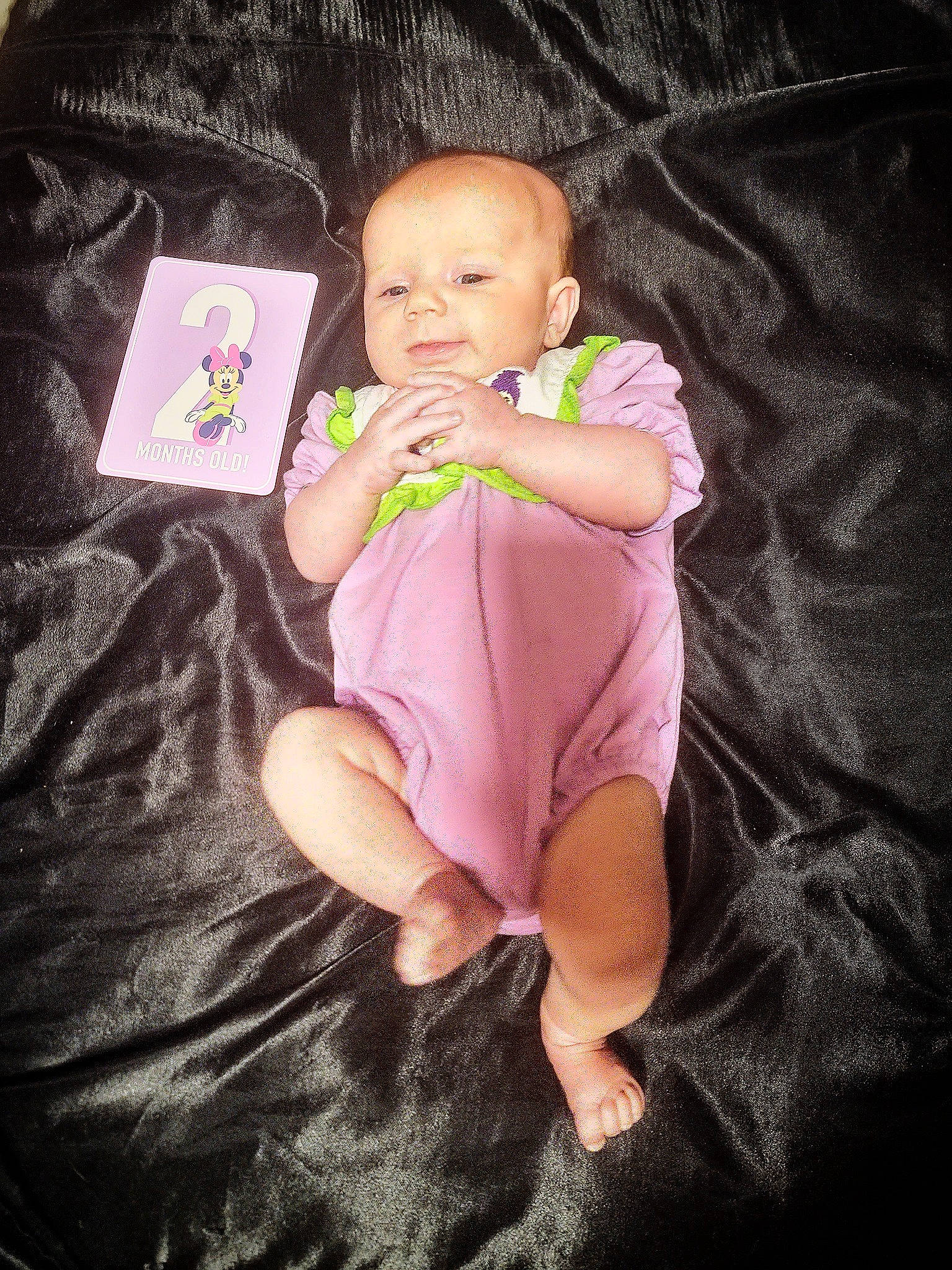 Persephone is registered to the contest to win money with this photo: baby, baby_toddler_clothing, cheek, child, comfort, face, foot, gesture, happy, linens, magenta, nail, person, pink, purple, sitting, sleeve, sock, t_shirt, thumb