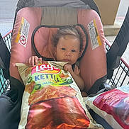 Blu joined the competition — help win amazing prizes! baby, car_seat, shopping_cart, chips, snack, lay's, kettle_cooked, jalapeno, food_package, child, person, pink, seat, hand, grocery, store, retail, plastic, shopping, cute