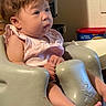 Blu joined the competition — help win amazing prizes! baby, infant, child, seat, pink_clothing, indoor, curly_hair, chubby_cheeks, plastic_seat, gazing, wide_eyes, skin, hand, foot, toes, blurred_background, household_items, soft_lighting, portrait, cute