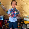 child, boy, toy, ball, spiderman, birthday, celebration, shoes, shorts, shirt, indoor, smile, hair, gift, box, background, decorations, happy, portrait, person