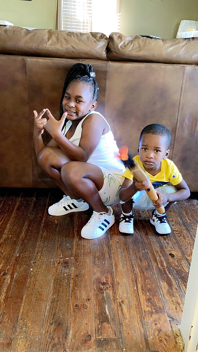 Zaniyah joined the competition — help win amazing prizes! baby_toddler_clothing, child, cool, face, floor, flooring, foot, fun, happy, hardwood, human_leg, joy, leisure, person, shoe, skin, smile, sneakers, t_shirt, thigh