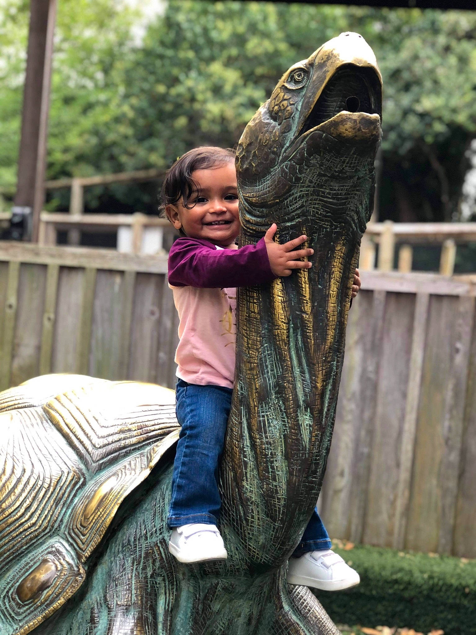 Mila Rose is registered to the contest to win money with this photo: adaptation, art, fence, fun, grass, happy, joy, leisure, mammal, people_in_nature, person, plant, recreation, reptile, smile, standing, temple, toddler, tree, vertebrate