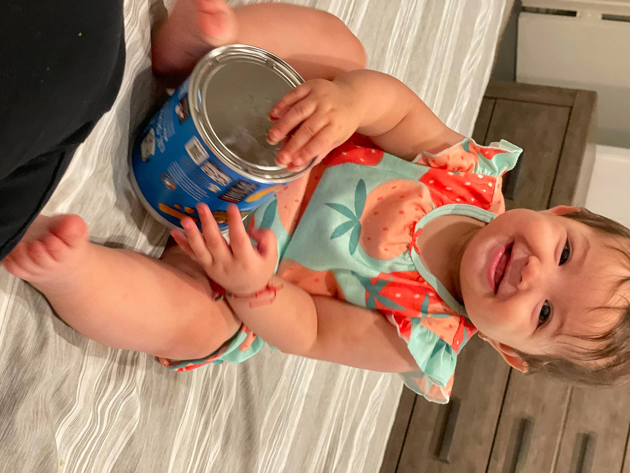 Camila is registered to the contest to win money with this photo: arm, baby, baby_toddler_clothing, chest, child, drinkware, finger, hand, happy, human_body, human_leg, joy, leg, mouth, nail, person, skin, smile, thigh, toddler