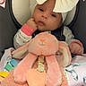 Aurora is registered to the contest to win money with this photo: baby, infant, child, portrait, car_seat, bow, headband, plush_toy, octopus, stuffed_animal, pink, sitting, indoors, blanket, baby_clothing, wide_eyed, face, hands, cuddling, cute