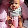 baby, infant, child, smiling, sitting, portrait, pink, chair, cup, container, indoor, close_up, face, eyes, hair, shirt, barefoot, legs, happy, photography