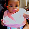 baby, infant, child, pink_bib, onesie, animal_print, curly_hair, big_eyes, glossy_lips, hand, arm, person, indoor, kitchen, refrigerator, chair, heart_effects, digital_overlay, holding, cute
