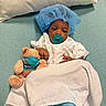 Jiovonni joined the competition — help win amazing prizes! baby, infant, child, hospital, medical, surgical_cap, pacifier, teddy_bear, face_mask, white_gown, blanket, bed, portrait, lying_down, indoor, caregiving, toy, blue, healthcare, adorable