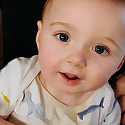 Cairo is registered to the contest to win money with this photo: baby, child, face, eyes, expression, shirt, colorful, curious, close_up, portrait, infant, young, cute, human, skin, head, person, clothing, background, indoor