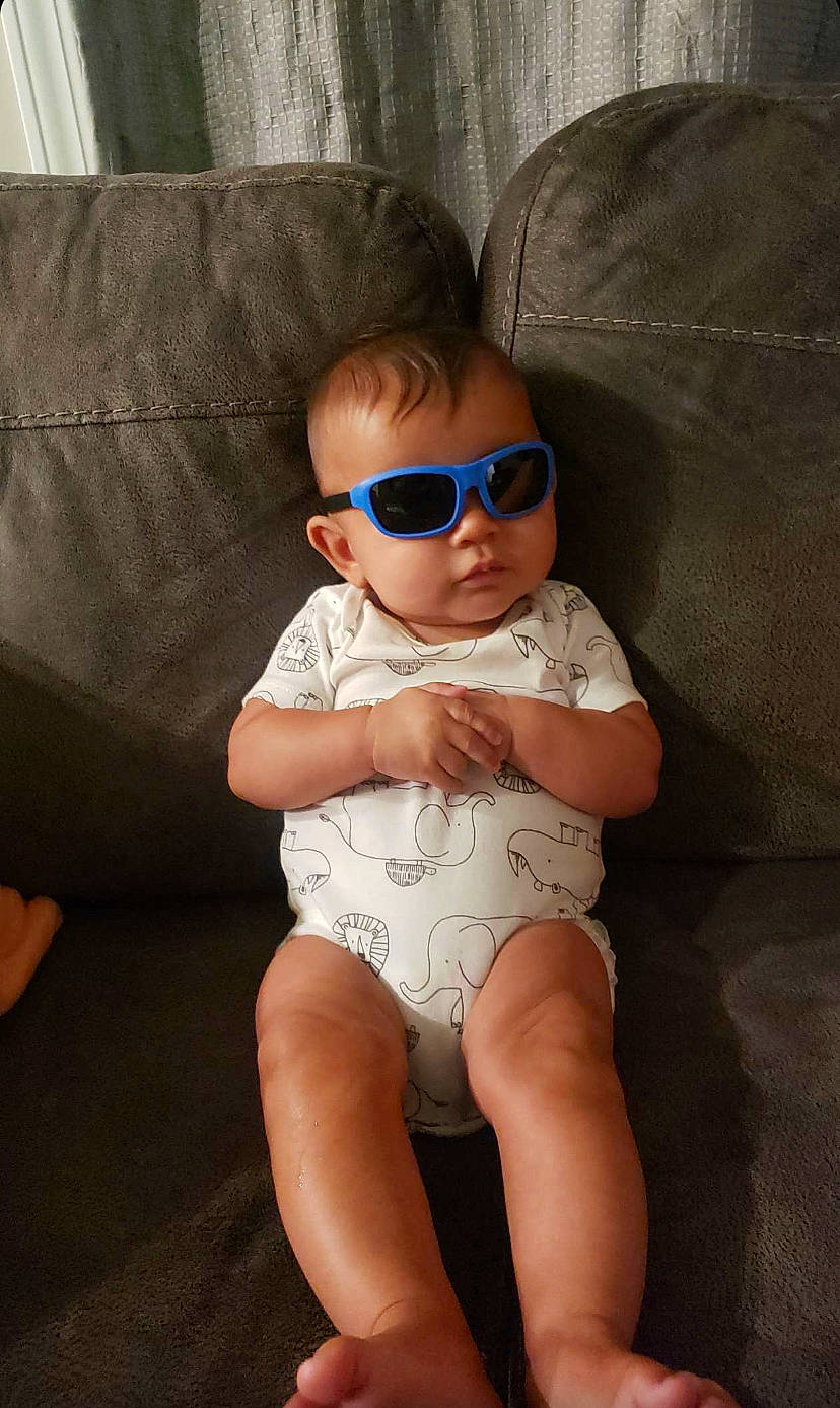Maisie joined the competition — help win amazing prizes! arm, baby, baby_toddler_clothing, comfort, couch, eye, eyewear, glasses, goggles, hand, head, human_body, knee, leg, neck, person, sunglasses, thigh, toddler, trunk