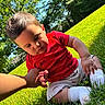 James Andrew Garcés is registered to the contest to win money with this photo: toddler, child, grass, outdoor, sunlight, hand_holding, red_shirt, white_socks, nature, greenery, baby, summer, park, casual_clothing, portrait, cute, daylight, playing, sitting, person