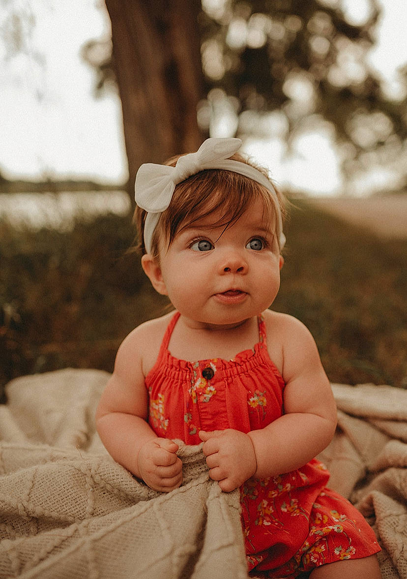 Kenna joined the competition — help win amazing prizes! baby, baby_toddler_clothing, child, day_dress, dress, eye, flash_photography, fun, grass, hair, happy, head, lip, people_in_nature, person, sitting, skin, sleeve, toddler, tree