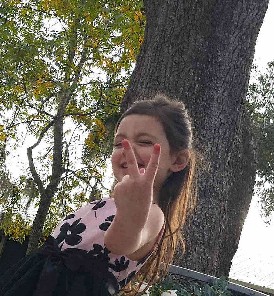 Kairi is registered to the contest to win money with this photo: brown_hair, eyewear, forest, fun, gesture, grass, happy, leisure, long_hair, pattern, people_in_nature, person, portrait_photography, sitting, t_shirt, tints_and_shades, tree, trunk, twig, wood